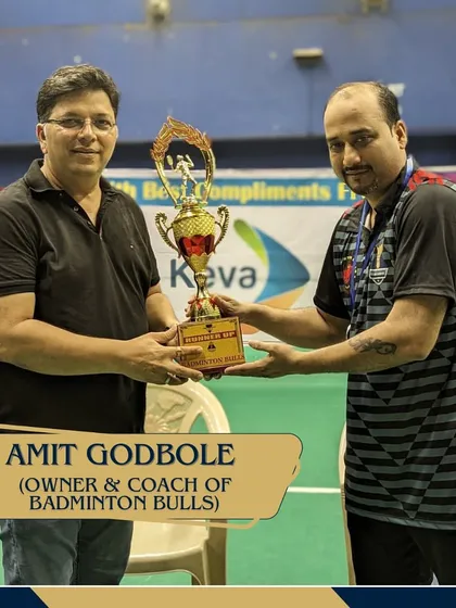 Amit Godbole, owner and coach of the runner-up team Badminton Bulls, receiving the trophy for his team's excellent performance.