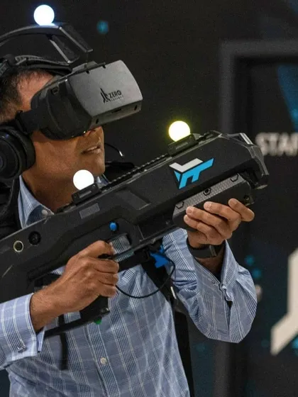 A participant takes aim with a haptic rifle in our VR shooting simulator. This setup provides a realistic and tactical experience, ideal for competitive fun and team-based challenges at any event.