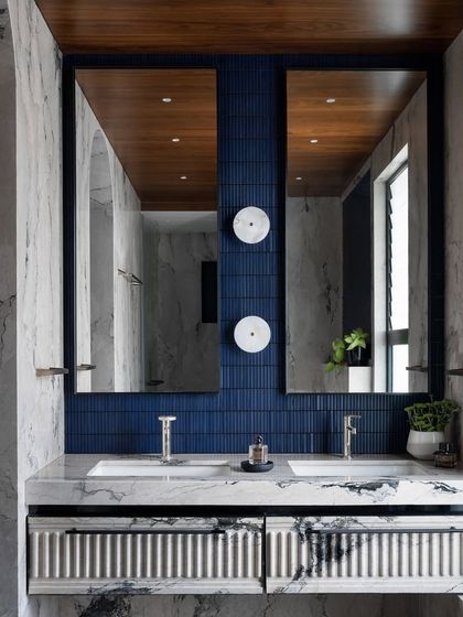 The master bathroom is a modern interpretation of ancient Moroccan baths. We used bold blue tiles, dual sinks set in a monolithic marble counter, and a fluted vanity to create a spa-like escape that feels both intricate and serene.