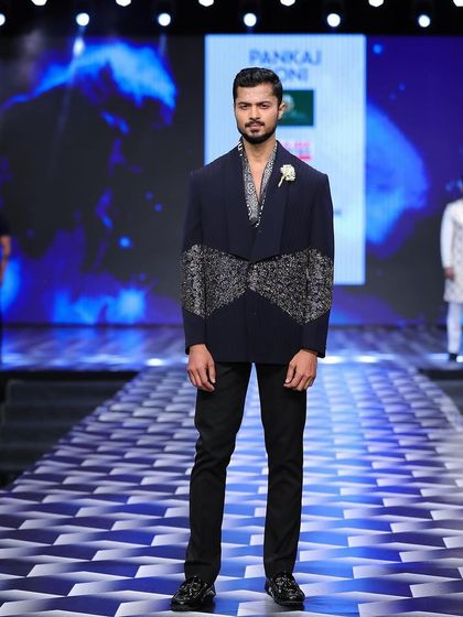 A full-frontal look at a designer piece by Pankaj Soni on the Mysore Fashion Week runway, showcasing the sharp tailoring and embellishments.