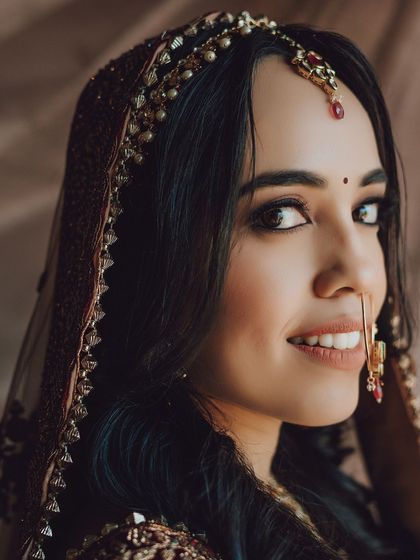 A lovely three-quarter portrait of the bride looking over her shoulder with a gentle smile.