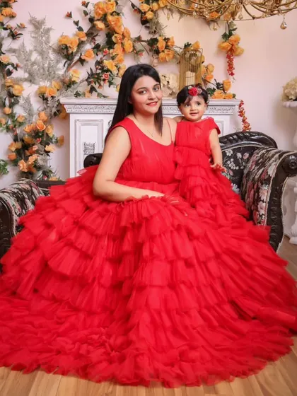 Go for bold with this vibrant red ruffled gown set. The voluminous tiered layers create a dramatic and fun look, ensuring you and your little one are the center of attention.