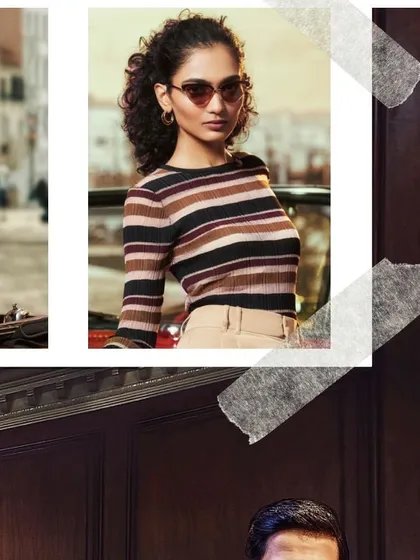 This John Jacobs Eyewear campaign shot features a retro-inspired look. The model's striped top and cat-eye sunglasses are styled to evoke a timeless, classic fashion sense that highlights the product's versatility.
