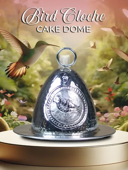 The Bird Cloche Cake Dome, where craftsmanship meets charm. The silver-finished dome is adorned with a delicate bird engraving and a ring handle, designed to turn your teatime treats into something truly memorable.