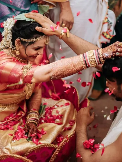 The couple is showered with rose petals, a moment of pure bliss.