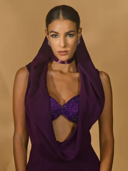 A striking close-up portrait from Nikhil Thampi's 'Amethyst Edit'. The focus is on the draped hood and embellished top, creating a bold and high-fashion image.