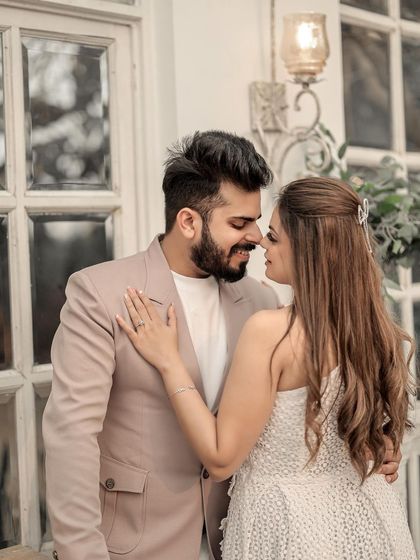 A sweet and tender close-up. This image captures the small, affectionate gesture of an almost-kiss, highlighting the couple's gentle and loving connection.