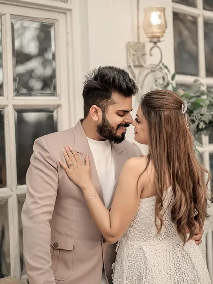 A sweet and tender close-up. This image captures the small, affectionate gesture of an almost-kiss, highlighting the couple's gentle and loving connection.