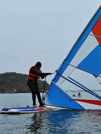 Learning to recover is part of the process. A windsurfer practices pulling his sail out of the water.