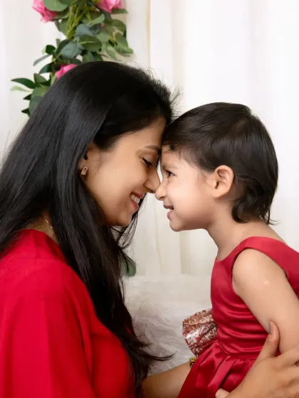 A quiet, intimate moment with foreheads touching. These are the simple, powerful moments that truly define the mother-daughter relationship.