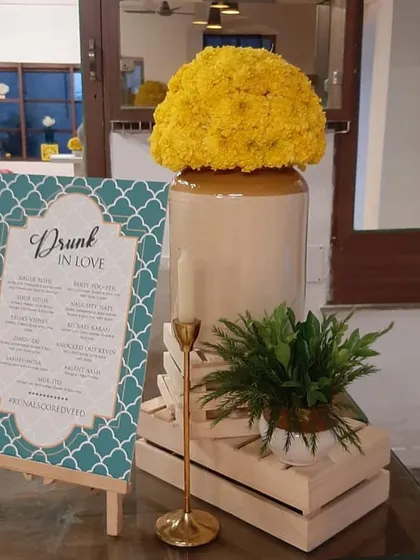 A custom 'Drunk in Love' bar menu designed for a cocktail party or engagement. We also incorporate thematic decor elements like marigold arrangements in traditional barni jars.