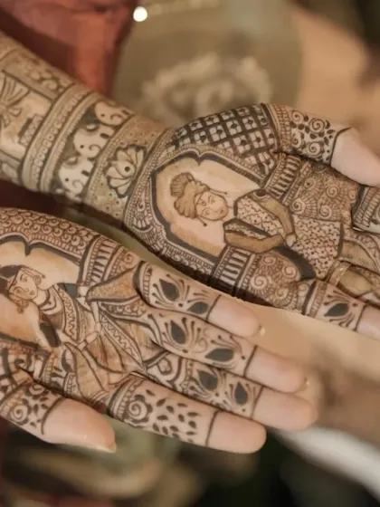 A close-up shot of a bridal mehendi with detailed portraits of the bride and groom. The clarity and precision in the figures are what I strive for in every portrait design.