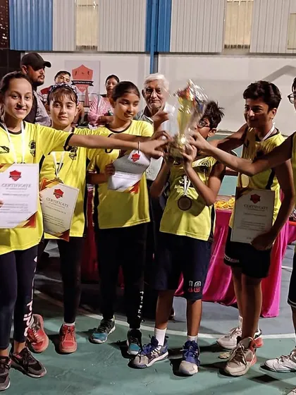 A glimpse of a tournament-winning moment. The smiles and certificates say it all.