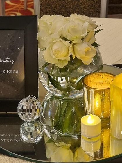 Another table centerpiece detail from the Sangeet. The mirrored base reflects the candlelight and the mini disco ball, adding extra sparkle and tying into the glamorous theme of the night.