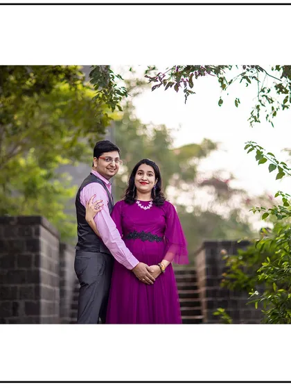 A lovely portrait of the couple, with the dad-to-be gently holding his partner and her baby bump.
