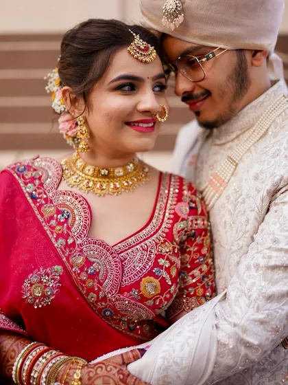 A close-up of a classic red bridal look. The focus is on creating luminous skin, beautifully defined eyes, and a bold lip that complements the traditional attire, ensuring the bride feels radiant and confident. ❤️