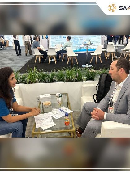 A one-on-one meeting with a potential client at our booth, discussing the future of renewable energy.