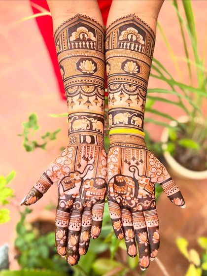 A slightly different angle of the elephant and lotus design, showing how the patterns flow seamlessly from the palm to the forearm. The use of negative space makes the motifs pop.