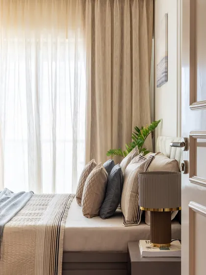 A glimpse into a parents' room. To create an illusion of height, we extended the curtains from the ceiling. The neutral color palette adds to the airy, serene, and age-appropriate feel of the space.