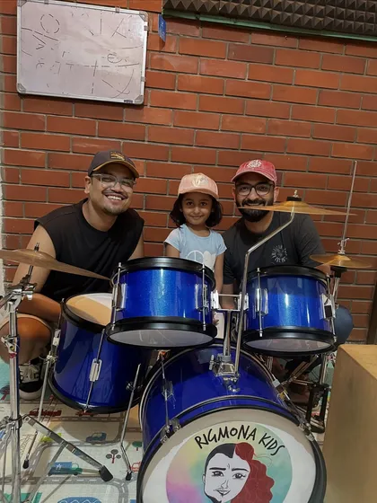 A happy moment captured at our studio. It's always a joy to see our students, like little Inara here, smiling after a productive and fun drum session.
