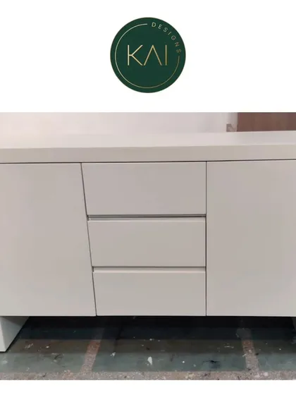 A minimalist sideboard in a clean white finish with handleless drawers and cabinets. This piece is perfect for creating an uncluttered look, offering sleek and discreet storage.
