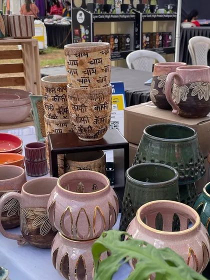 My stall featuring stacks of my popular 'Chai' and 'Coffee' cups, alongside hand-carved mugs and perforated luminaries. Markets are a great way to reach new people.