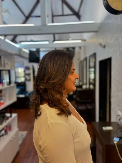 A side view of the summer-ready layered haircut, showing how it frames the face and adds volume.