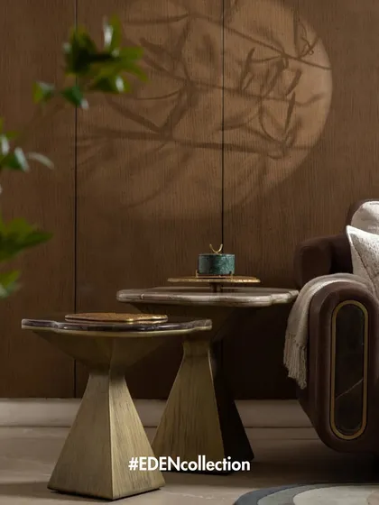 A detail from the Eden Collection, featuring two nested side tables with brass and resin tops. The design focuses on the interplay of different materials and geometric shapes to create elegant, functional pieces.