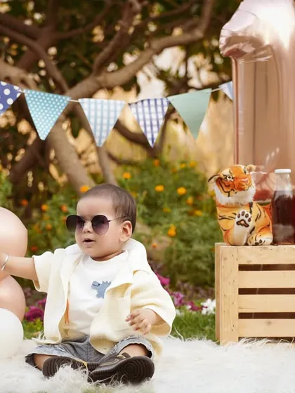 Too cool for school. The birthday boy puts on sunglasses during his outdoor picnic shoot, showing off his budding personality.