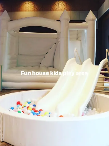 Our white bounce castle paired with a separate white ball pit and slide, offering a modular setup for different space requirements.
