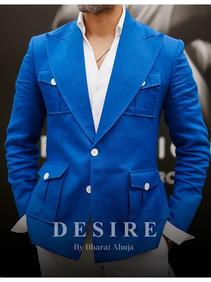 A closer look at the construction of the blue blazer, showing the detailed stitching and functional pocket design. Craftsmanship is at the core of everything I do.