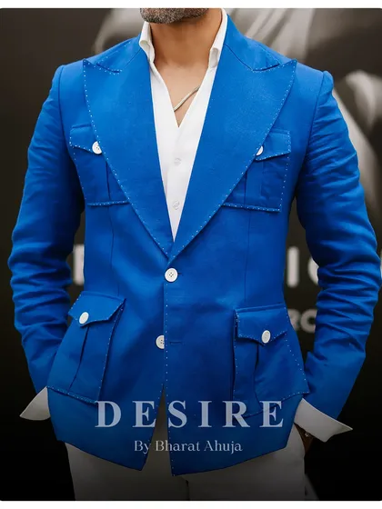 A closer look at the construction of the blue blazer, showing the detailed stitching and functional pocket design. Craftsmanship is at the core of everything I do.