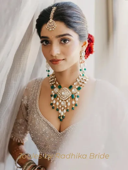 A portrait of modern royalty. This bride chose a statement polki and emerald necklace with a matching maang tikka, creating a look that is both classic and breathtakingly beautiful.