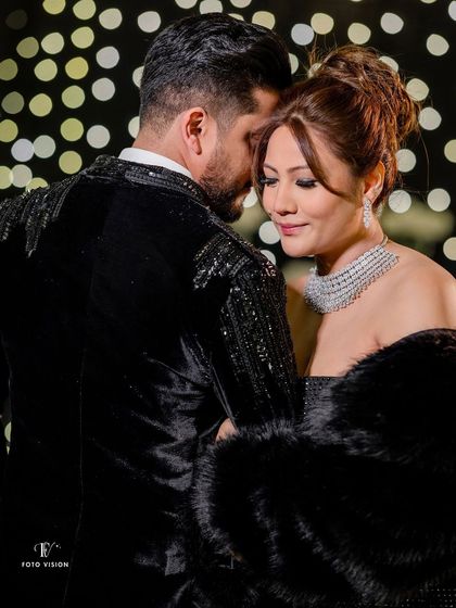An intimate moment from behind, focusing on the bride's expression and her stunning diamond necklace. This angle provides a unique and emotional perspective.