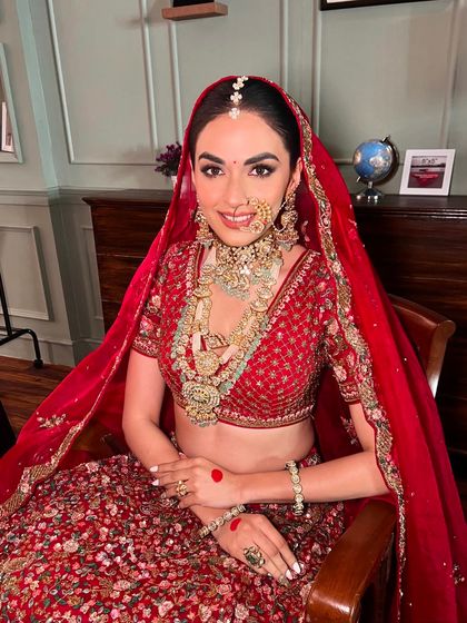 A close-up of this classic red bridal look, showing the soft contouring and radiant skin. The goal is always to make you feel confident and beautiful while honoring your heritage.