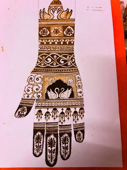 A design sketch of a swan motif. Every intricate design begins with an idea and a drawing, planning the flow and details before the cone touches the skin.
