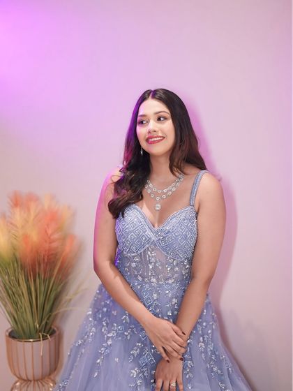 Another beautiful shot of this princess moment. The soft lighting highlights the radiant finish of her makeup and the gentle waves in her hair, creating a truly magical Sangeet look.