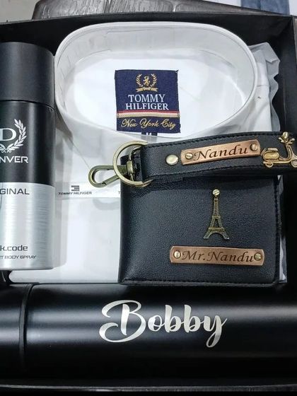 A white Tommy Hilfiger shirt paired with a personalized wallet, keychain, and flask makes for a timeless gift.
