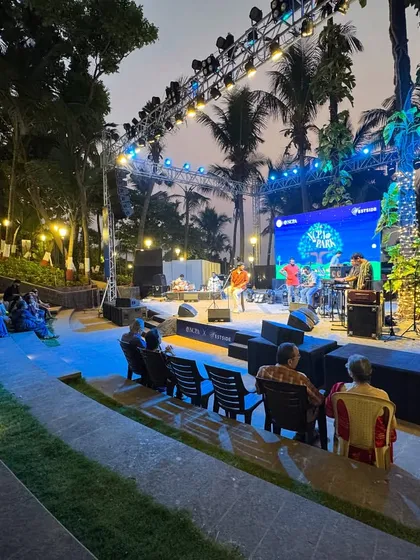 A wide shot of a concert at the Bandra Fort amphitheater, showing the stage, lighting, and audience. This demonstrates the successful realization of our design vision for a functional and acoustically sound performance venue that enhances Mumbai's cultural landscape.