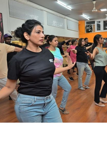 A focused moment during a Salsa shines routine. Lady styling is an important part of our curriculum, empowering dancers to express themselves.