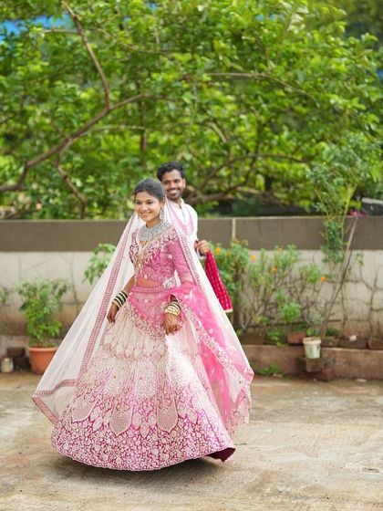 Another beautiful shot of our client in the pink and white lehenga. The full outfit, including the sheer dupatta, creates a soft and romantic bridal look.