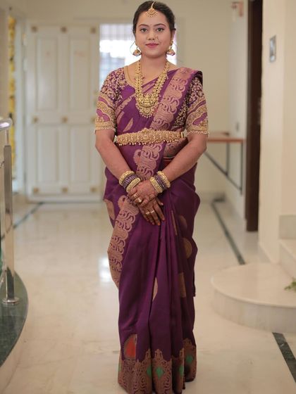 A full-length view of Madhu's saree, showcasing the rich brocade work on the border and pallu.