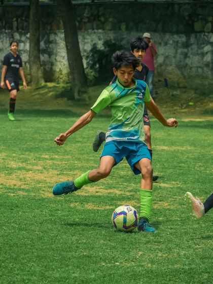 A player controls the ball, looking to make a pass to a teammate.