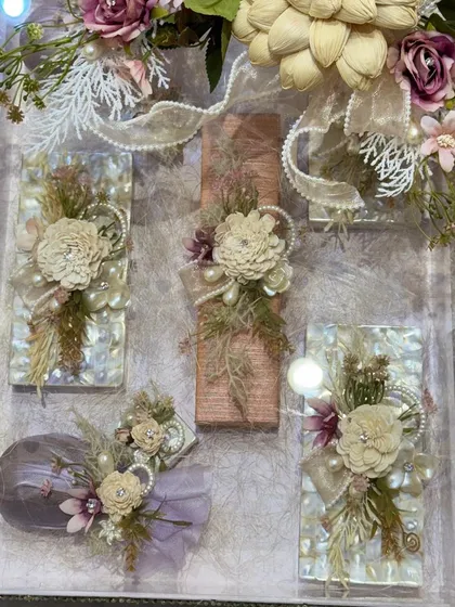 An exquisite trousseau packing solution. This clear acrylic box is filled with gifts, each individually wrapped and adorned with delicate sola wood flowers and pearls for a soft, romantic aesthetic.