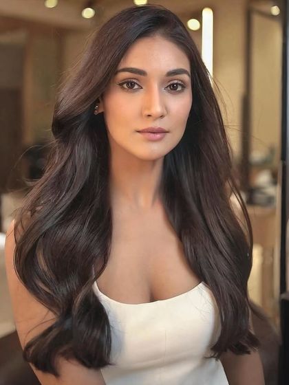 The final result for Mukti Mohan. A rich, glossy brown that moves with the light and perfectly frames her features, showcasing an effortless and elegant hair transformation.