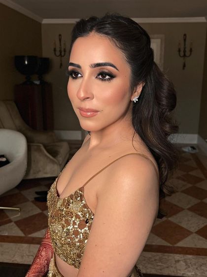 A portrait of the bride, her simple half-up style allowing her makeup and jewelry to take center stage.