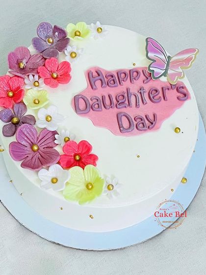 A simple and beautiful cake for Daughter's Day, decorated with pastel flowers and a butterfly.
