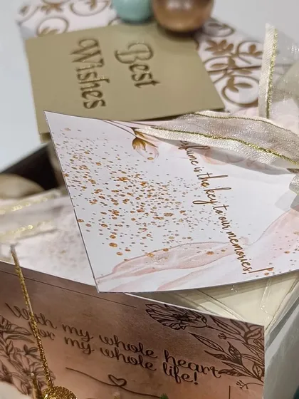 A close-up of the custom card, which reads "Time is the key to our memories," adding a sentimental touch to the engagement gift.