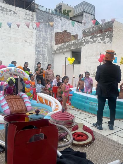 We can set up a complete pool party with multiple inflatable pools, including one with a slide. I'm here entertaining the kids who are taking a break from the water.