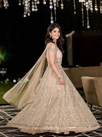 A beautiful twirling shot of the bride in her glittering gown, the motion capturing the magic and sparkle of the evening.